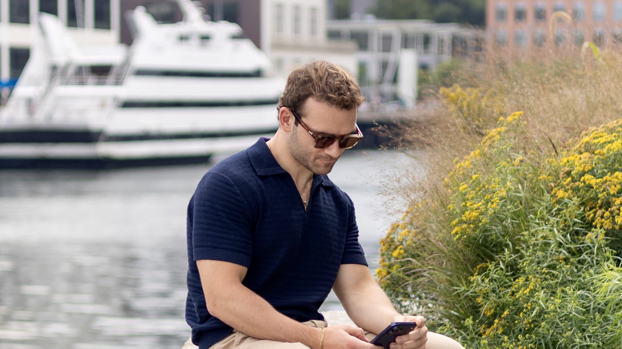 Derek Jesiolowski reviewing market information beside Boston Harbor